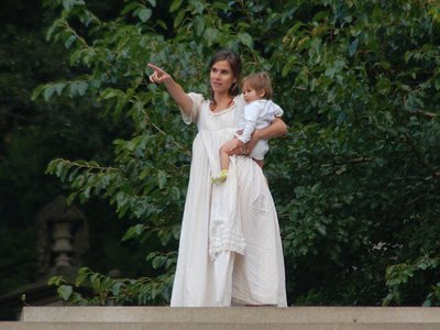 A human angel with young child points toward the horizon at Green-Wood Cemetery's annual Angels and Accordions Festival