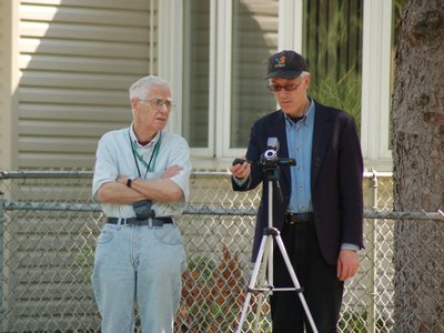 Steve Baldwin, of BrooklynParrots.com, stands with a neighborhood resident and documents the removal of wild Quaker Parrot nests at the Throggs Neck Little League baseball field, Throggs Neck, the Bronx, New York City, June 7, 2007